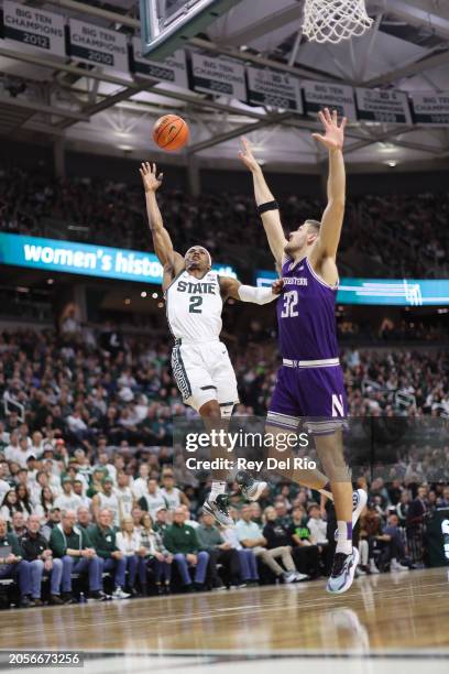 Tyson Walker of the Michigan State Spartans shoots a layup over Blake Preston of the Northwestern Wildcats during the first half at Breslin Center on...