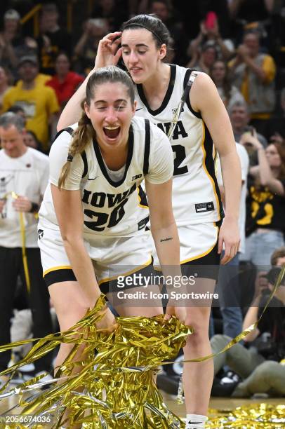 Iowa guard Kate Martin gathers up the streamers dropped during a Senior Day ceremony after a women's college basketball game between the Ohio State...