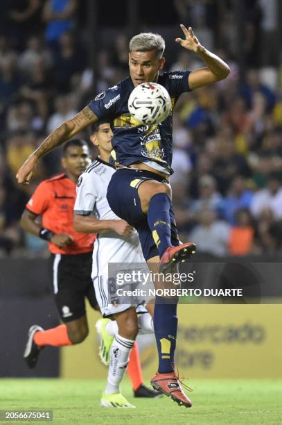 Sportivo Trinidense's forward Oscar Gimenez and Colo-Colo's midfielder Esteban Pavez fight for the ball during the Copa Libertadores third round...