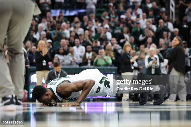 Mady Sissoko of the Michigan State Spartans kisses the center court logo on senior day after the game against the Northwestern Wildcats between the...