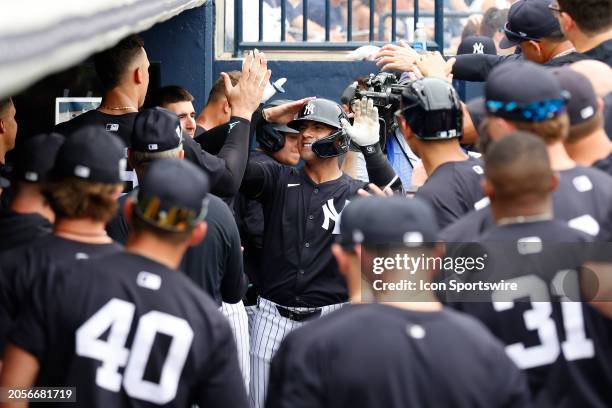 New York Yankees infielder Gleyber Torres is congratulated by his teammates in the dugout after hitting a home run against the Tampa Bay Rays during...