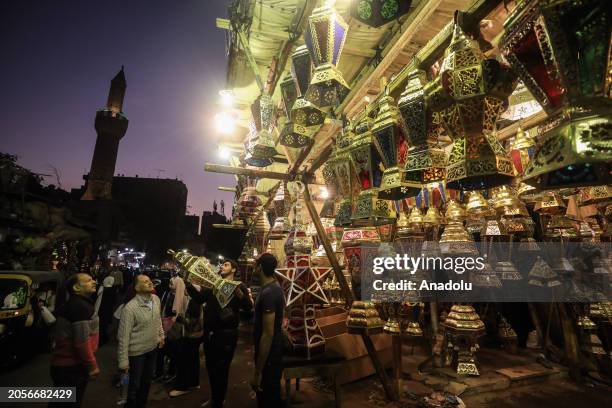 Lanterns of various colors, patterns and sizes are laid out for sale on the market stalls to decorate people's homes and streets during the upcoming...