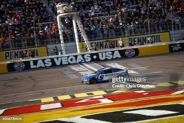 Kyle Larson, driver of the HendrickCars.com Chevrolet, crosses the finish line to win the NASCAR Cup Series Pennzoil 400 at Las Vegas Motor Speedway...