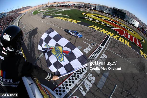 Kyle Larson, driver of the HendrickCars.com Chevrolet, takes the checkered flag to win the NASCAR Cup Series Pennzoil 400 at Las Vegas Motor Speedway...