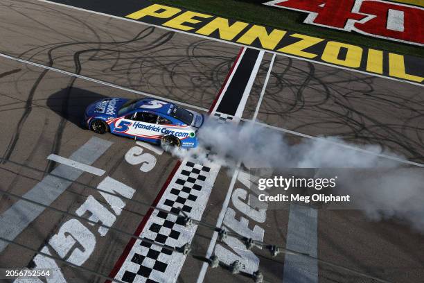 Kyle Larson, driver of the HendrickCars.com Chevrolet, celebrates with a burnout after winning the NASCAR Cup Series Pennzoil 400 at Las Vegas Motor...