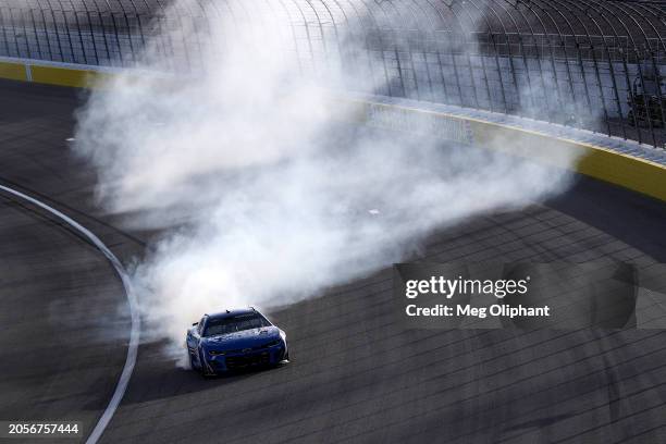 Kyle Larson, driver of the HendrickCars.com Chevrolet, celebrates with a burnout after winning the NASCAR Cup Series Pennzoil 400 at Las Vegas Motor...