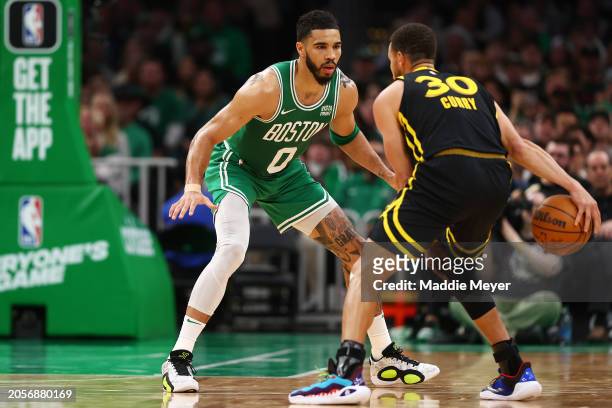 Jayson Tatum of the Boston Celtics defends Stephen Curry of the Golden State Warriors during the second quarter at TD Garden on March 03, 2024 in...