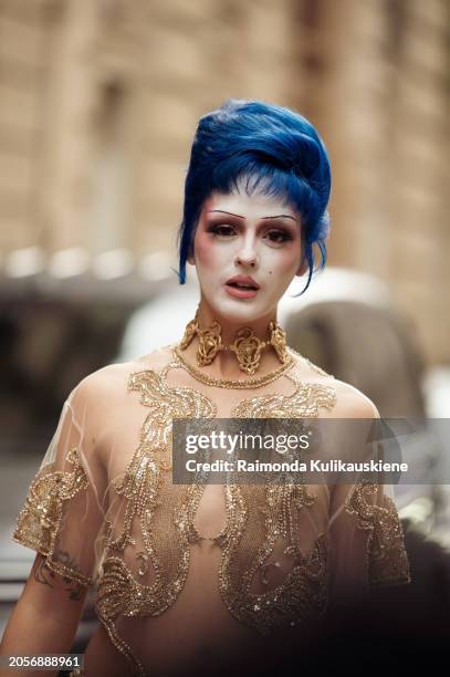 Sita Abellan in blue hair wears sheer golden and beige sheer maxi skirt and sheer matching top, and white and pink makeup outside Valentino during...