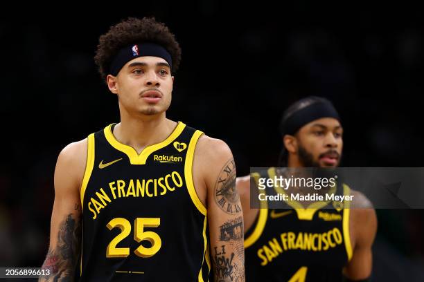Lester Quinones of the Golden State Warriors and Moses Moody looks on during the first quarter against the Boston Celtics at TD Garden on March 03,...