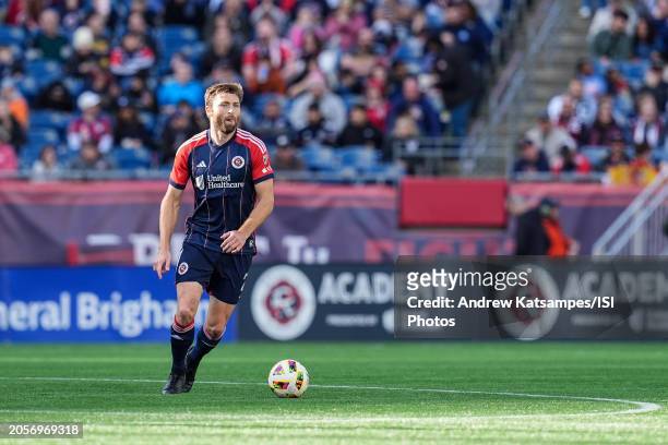 Dave Romney of New England Revolution brings the ball forward during a game between Toronto FC and New England Revolution at Gillette Stadium on...