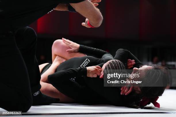 Raquel Canuto secures a rear choke submission against Karol Rosa during the UFC Fight Pass Invitational 6 at UFC APEX on March 03, 2024 in Las Vegas,...