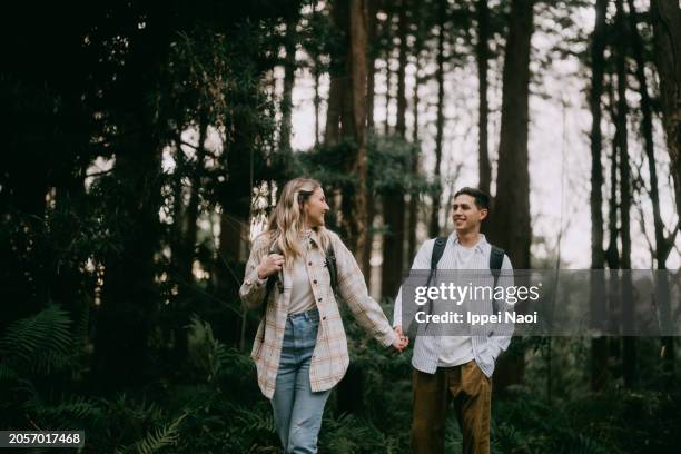 young couple hiking in forest - romantic pics for her stock pictures, royalty-free photos & images