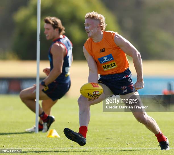 Clayton Oliver of the Demons handballs during a Melbourne Demons AFL training session at Casey Fields on March 04, 2024 in Melbourne, Australia.