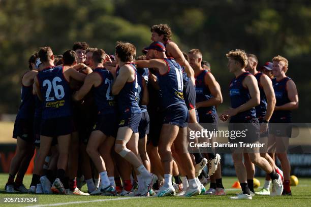 Players congratulate Caleb Windsor on being named to debut during a Melbourne Demons AFL training session at Casey Fields on March 04, 2024 in...