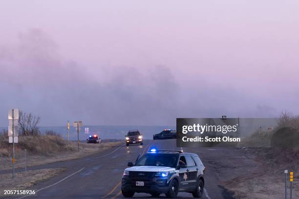 State police block the road to Sanford as firefighters battle flames from the Smokehouse Creek fire on March 03, 2024 near Sanford, Texas. The fire...