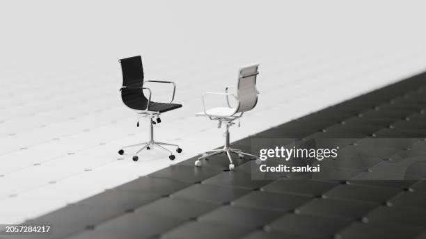the concept of choice, challenge and partnership. black and white office chairs stands against each other on the abstract black and white tiled floor - entrevista imagens e fotografias de stock