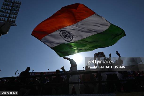 An Indian cricket fan waves the flag of India in the stands during the first day of the fifth Test cricket match between India and England at the...