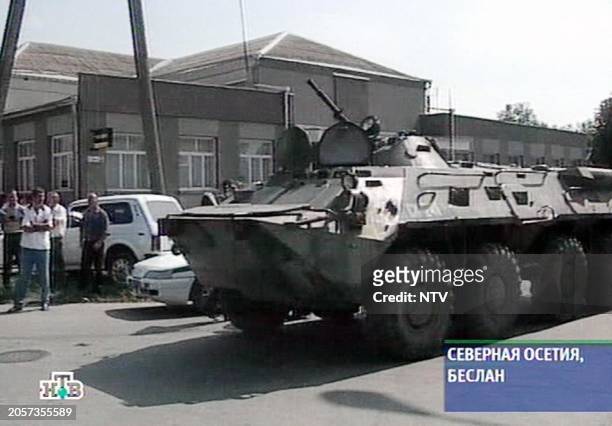 Grab image taken from the Russian NTV channel 01 September 2004 shows a Russian armored perssonel carrier taking position during an operation in the...