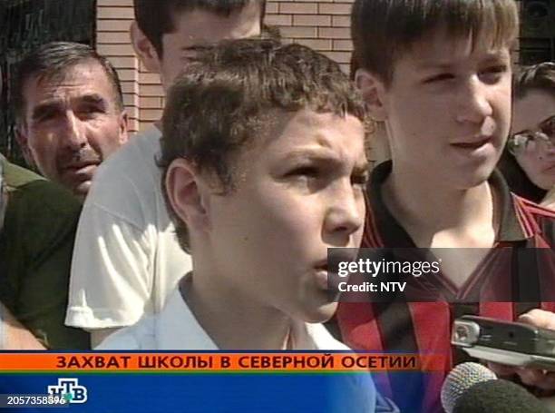 This TV grab image taken from Russian NTV channel, 01 September 2004 of pupils, who escaped from the gunmen that took up 240 hostage people at a...