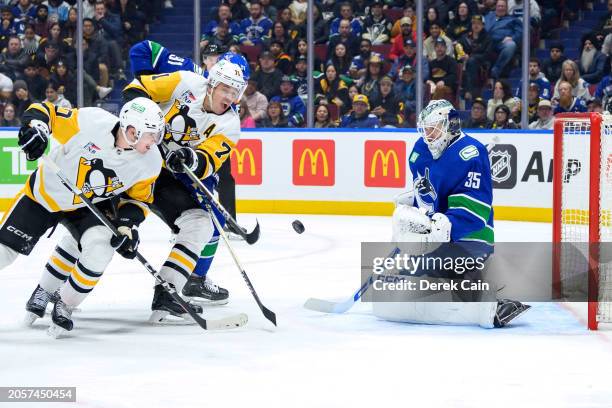 Thatcher Demko and Nikita Zadorov of the Vancouver Canucks defend against Evgeni Malkin and Drew O'Connor of the Pittsburgh Penguins during the third...