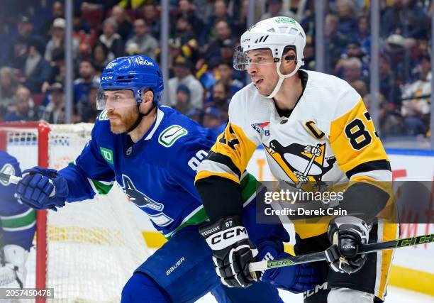 Ian Cole of the Vancouver Canucks defends against Sidney Crosby of the Pittsburgh Penguins during the third period of their NHL game at Rogers Arena...