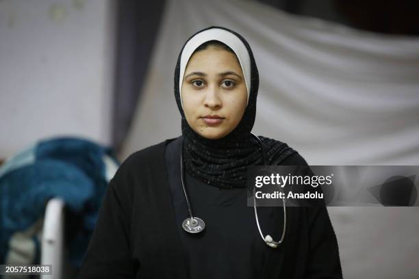 Fatima al-Atiyya, medical worker who took refuge in Deir al-Balah, treat the Palestinian patients at Al-Aqsa Martyrs Hospital in Deir al-Balah, Gaza...