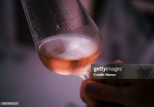 woman with glass of rosé in hand - betrunken stock-fotos und bilder