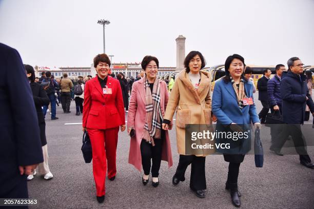 Members of the 14th National Committee of the Chinese People's Political Consultative Conference walk to the Great Hall of the People before the...