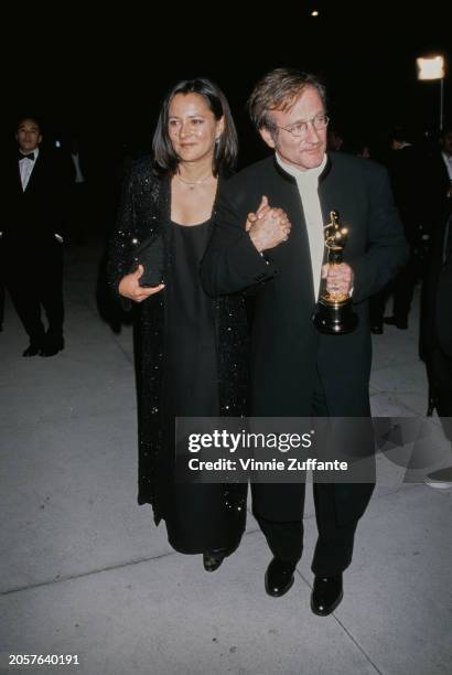 Robin Williams and wife Marsha Garces Williams attend the 1998 Vanity Fair Oscar Party at Morton's Restaurant in Beverly Hills, California, 23rd...