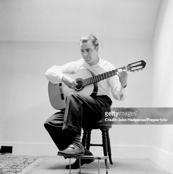 English classical guitarist Julian Bream plays an acoustic guitar in England circa 1960.