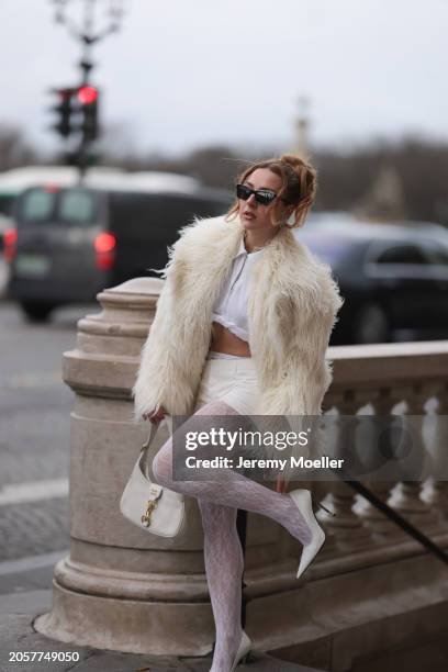 Damla Kalaycık seen wearing Chanel black sunglasses, Miu Miu silver diamond pendant earrings, Jacquemus white zip cropped shirt, Miu Miu creamy white...