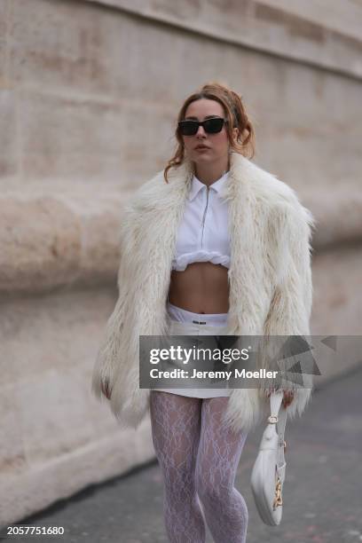 Damla Kalaycık seen wearing Chanel black sunglasses, Miu Miu silver diamond pendant earrings, Jacquemus white zip cropped shirt, Miu Miu creamy white...