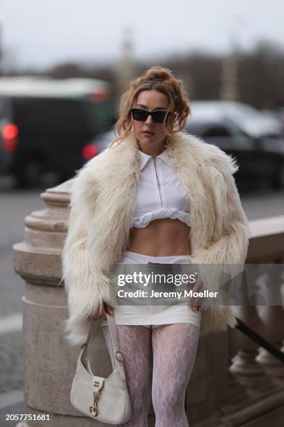 Damla Kalaycık seen wearing Chanel black sunglasses, Miu Miu silver diamond pendant earrings, Jacquemus white zip cropped shirt, Miu Miu creamy white...