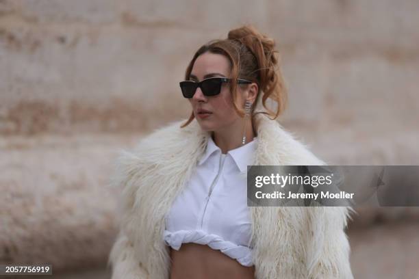 Damla Kalaycık seen wearing Chanel black sunglasses, Miu Miu silver diamond pendant earrings, Jacquemus white zip cropped shirt, The Frankie Shop...