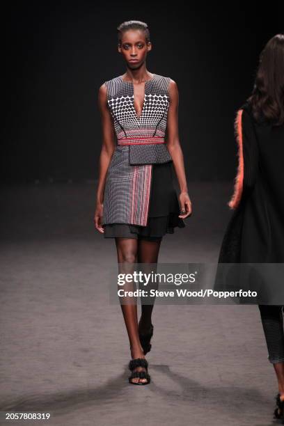 Model walks the runway at the Byblos show during Milan Fashion Week Autumn/Winter 2016/17, she wears a short sleeveless A line dress with a peplum...