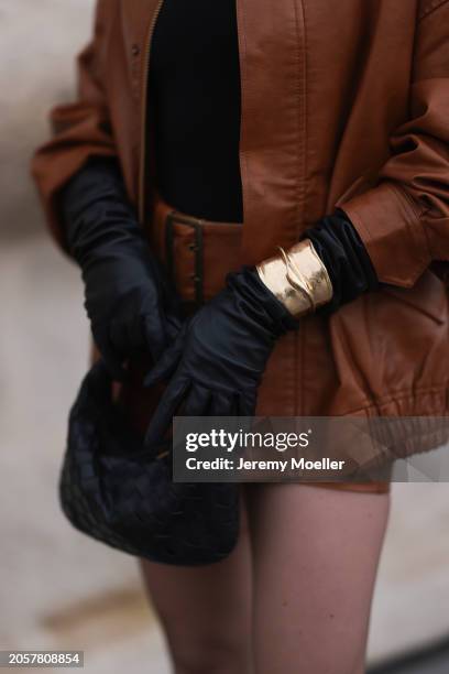 Berna Bilbey seen wearing COS black turtleneck top, Lioness brown oversized leather jacket, matching Lioness brown leather belted short skirt, gold...