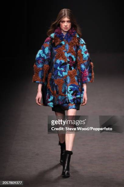 Model walks the runway at the Byblos show during Milan Fashion Week Autumn/Winter 2016/17, she wears a short dress and matching coat in blue and...