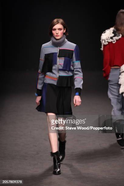 Model walks the runway at the Byblos show during Milan Fashion Week Autumn/Winter 2016/17, she wears a short pleated skirt and a zipped jacket in...