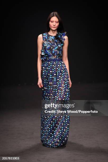 Model walks the runway at the Byblos show during Milan Fashion Week Autumn/Winter 2016/17, she wears a sleeveless maxi dress with a black and...