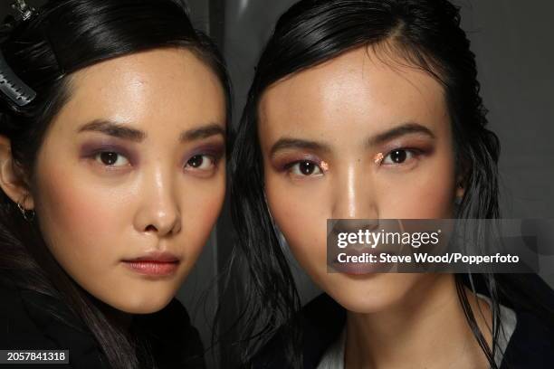 Backstage at the Cividini show during Milan Fashion Week Autumn/Winter 2016/17, close up of two models with their hair gelled and wearing smoky and...