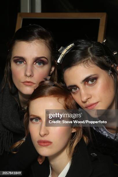 Backstage at the Cividini show during Milan Fashion Week Autumn/Winter 2016/17, close up of three models with their hair gelled and wearing smoky and...