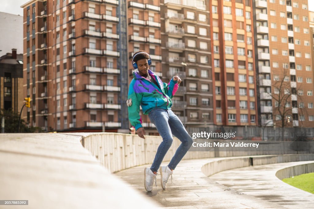African man dancing listening to music in the city