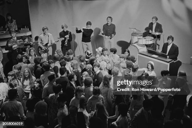 English rock and pop group Manfred Mann perform in front of a studio audience on the set of a pop music television show in London in 1966. Members of...