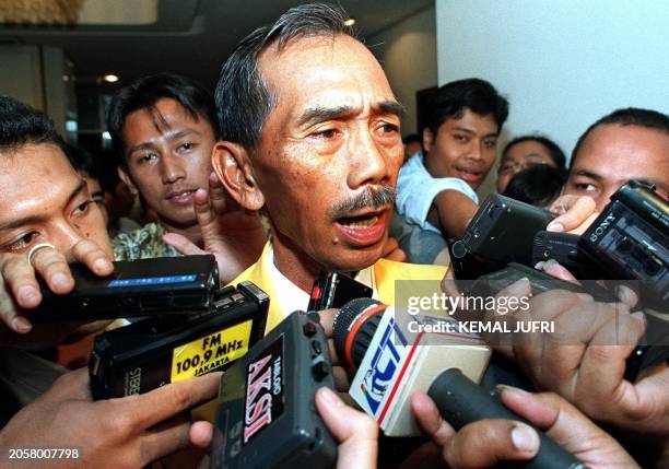 One of the two candidates in the running for leadership, retired general Edi Sudrajat is mobbed by reporters at the end of the second day of a the...