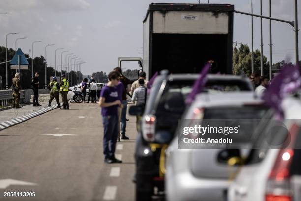 View of convoy of vehicles gathered by the non-governmental organization 'Standing Together', founded by Israeli and Arab activists is seen as...