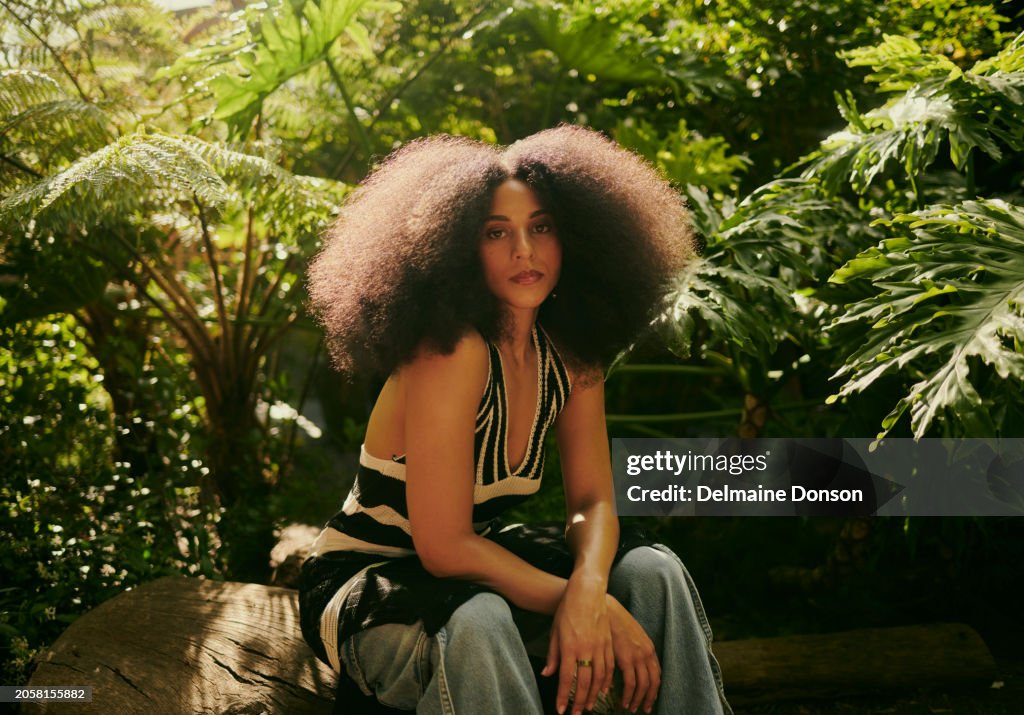Stylish Woman with Afro in a Garden Setting