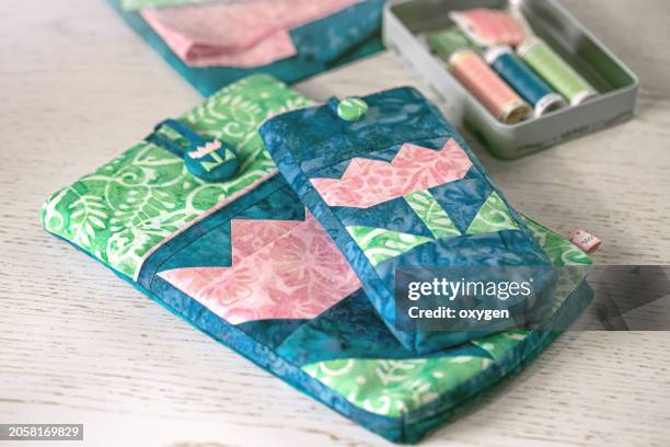 quilt book wallet, patchwork sewing cover for phone with tulip block. spring pink blue green color pallete - patchwork stock pictures, royalty-free photos & images