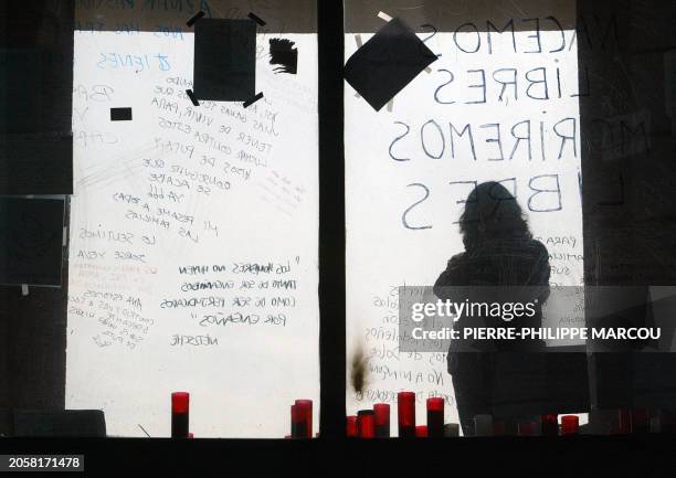 Person meditates during a ceremony in memory of the victims of the blasts at Atocha train station, 18 March 2004 in Madrid, a week after March 11...
