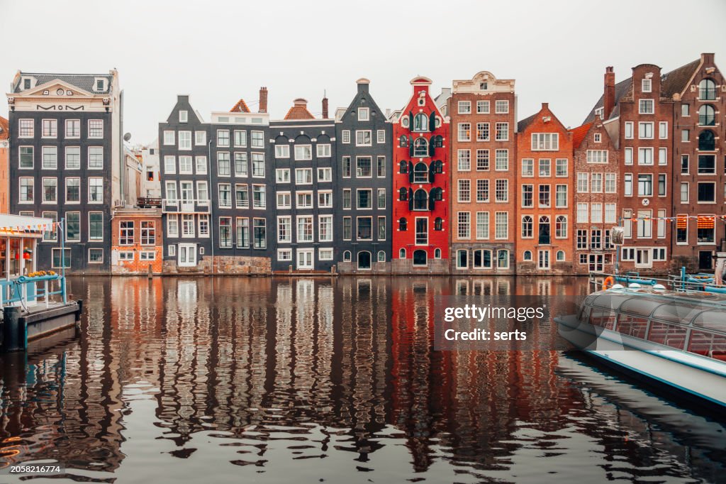 Typical Dutch Houses reflections on the water of the canal on a sunny day