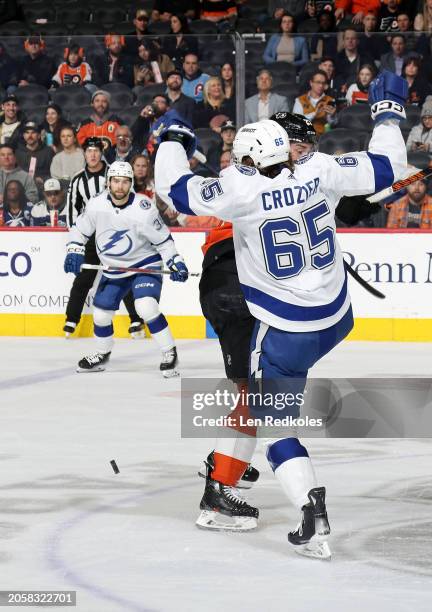 Noah Cates of the Philadelphia Flyers collides at center ice in a battle for the puck against Maxwell Crozier of the Tampa Bay Lightning at the Wells...